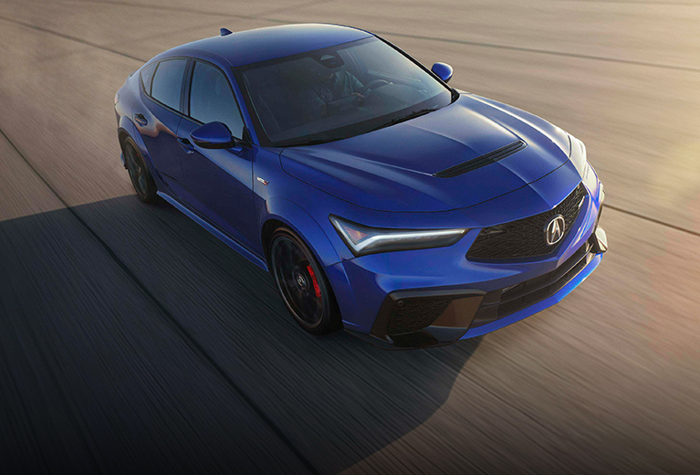 2025 Acura Integra Type S in Apex Blue Pearl top view driving on a paved track at high speed (Premium Sport Compact).